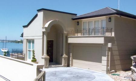 Architect designed house sitting right on the water’s edge looking down Sydney Harbour