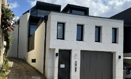 Architect design new home built around an existing home